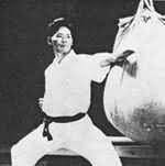 Yoshitaka Funakoshi striking the heavy bag with shuto-uchi.